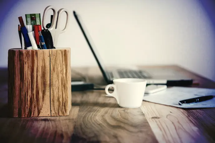 white ceramic mug on brown wooden table