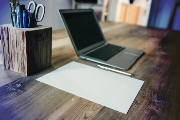 macbook pro on brown wooden table